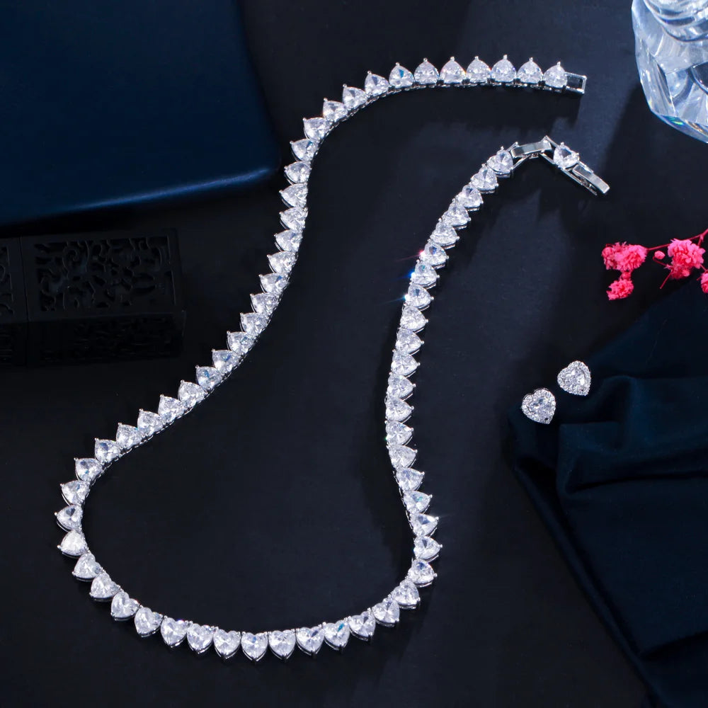 Heart-shaped cubic zirconia choker necklace with matching heart stud earrings, silver-tone.