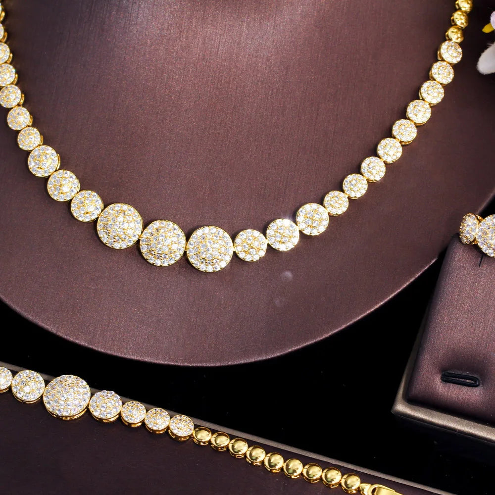 Close-up of gold-tone necklace and bracelet with graduated round CZ stones