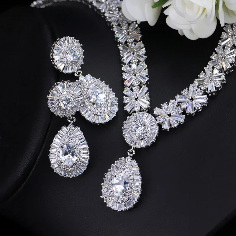 Silver-tone cubic zirconia necklace with matching earrings and round drops on a jewelry display