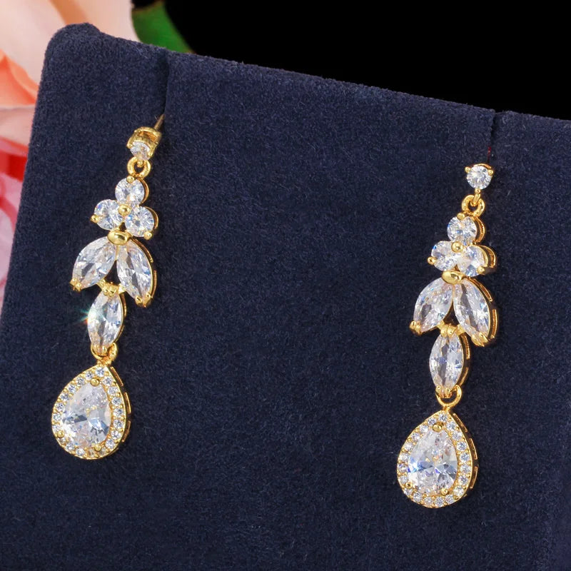 Close-up of gold-tone cubic zirconia drop earrings with marquise leaves and teardrop stones