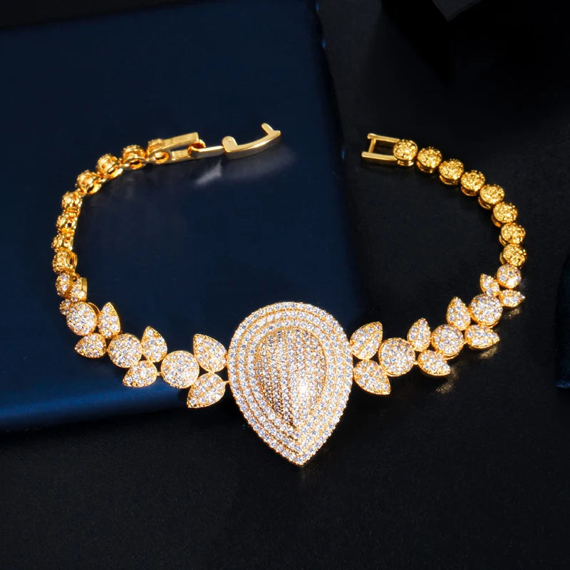 Gold-tone bracelet with teardrop zircon centerpiece and leaf-shaped stones
