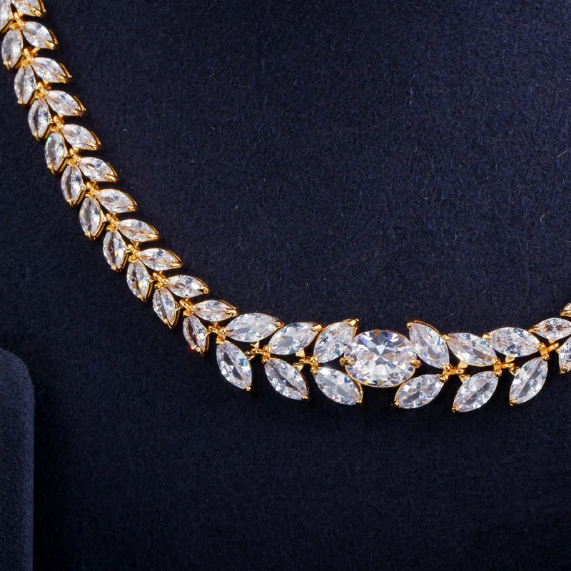 Close-up of gold-tone necklace with marquise cubic zirconia leaves and center stone