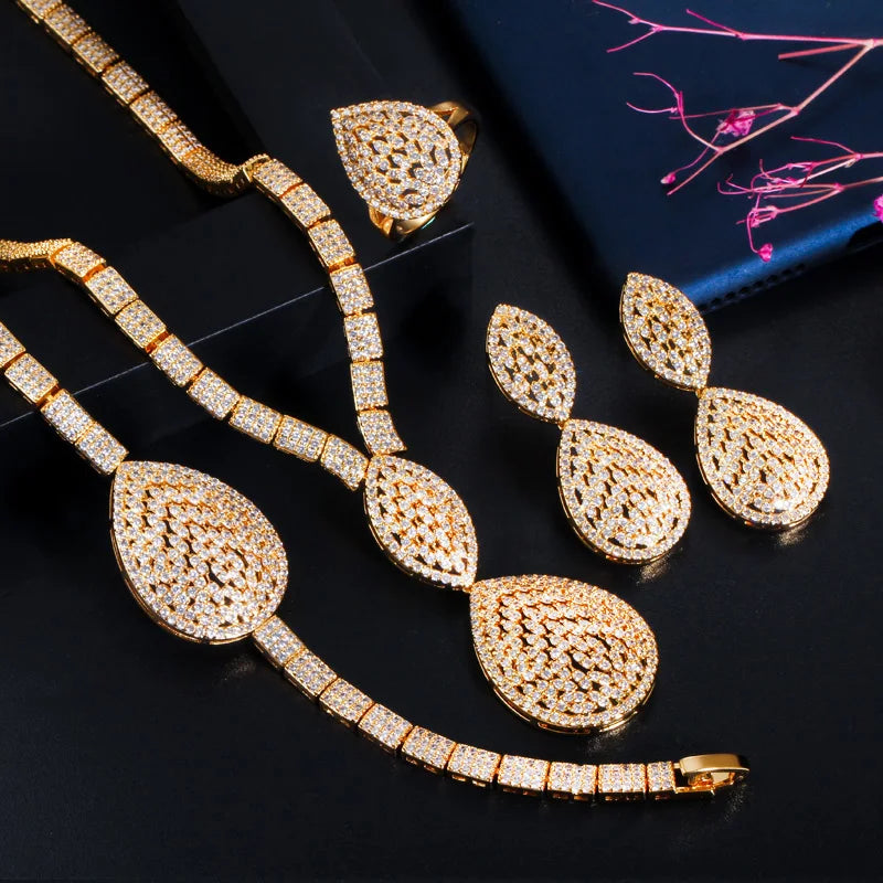 Gold-plated teardrop rhinestone necklace with matching drop earrings, angled close-up