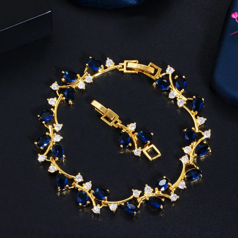 Gold-tone leaf branch bracelet with blue and clear cubic zirconia stones