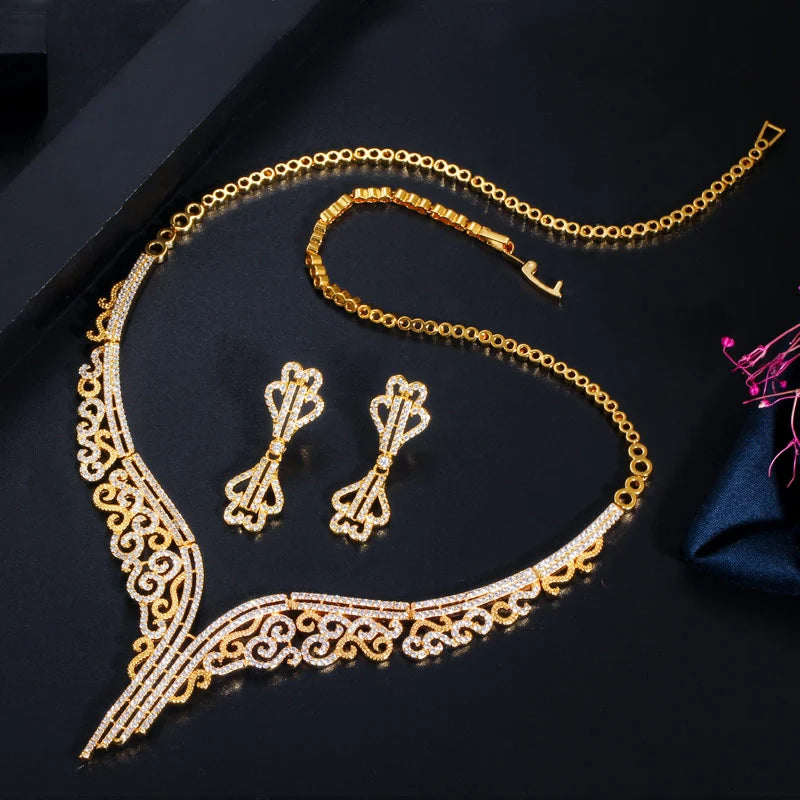 Gold-tone bridal set with a jeweled scrollwork necklace and matching long drop earrings