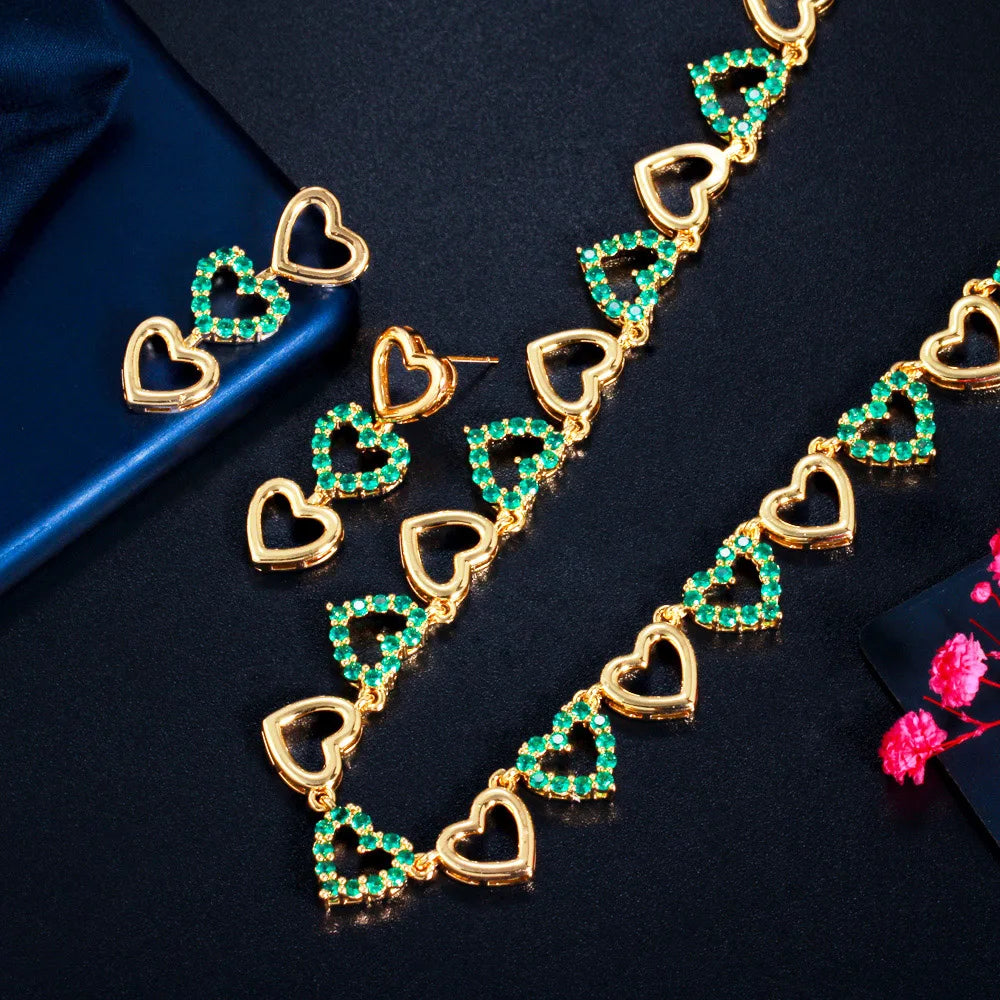 Gold-tone necklace and matching heart earrings with green stones
