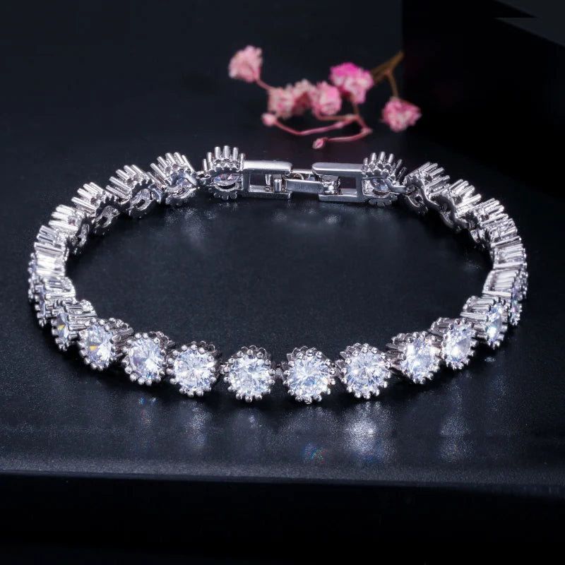 Silver-tone CZ tennis bracelet with round halo stones and a box clasp