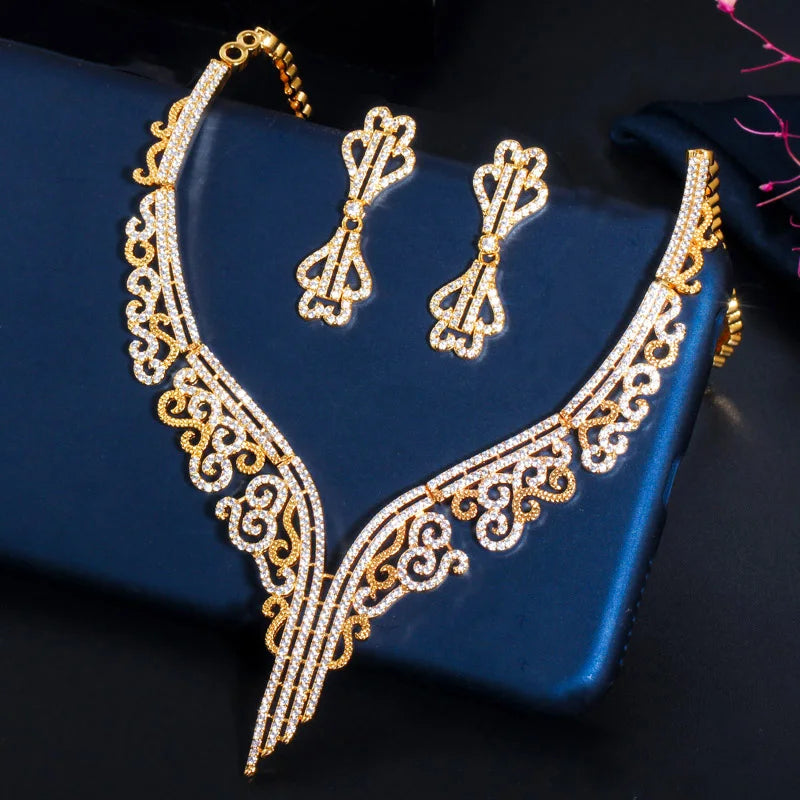 Gold-tone necklace and matching earrings with sparkling stones and ornate V-shaped design