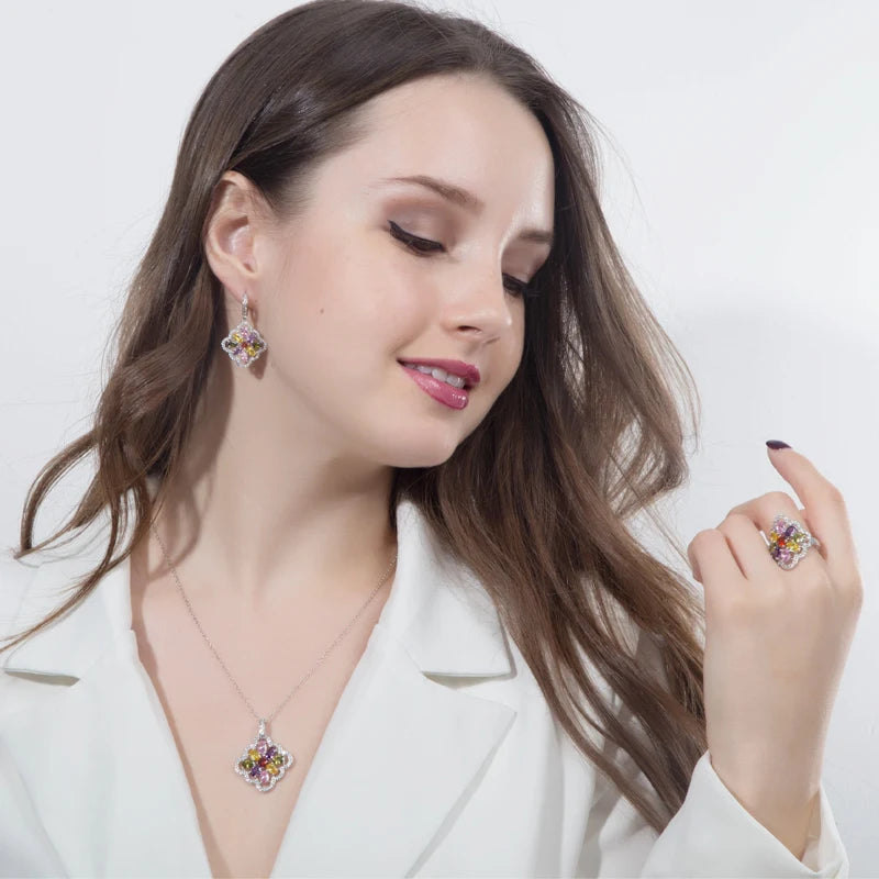 Model wearing multicolor floral zircon pendant necklace, drop earring, and ring