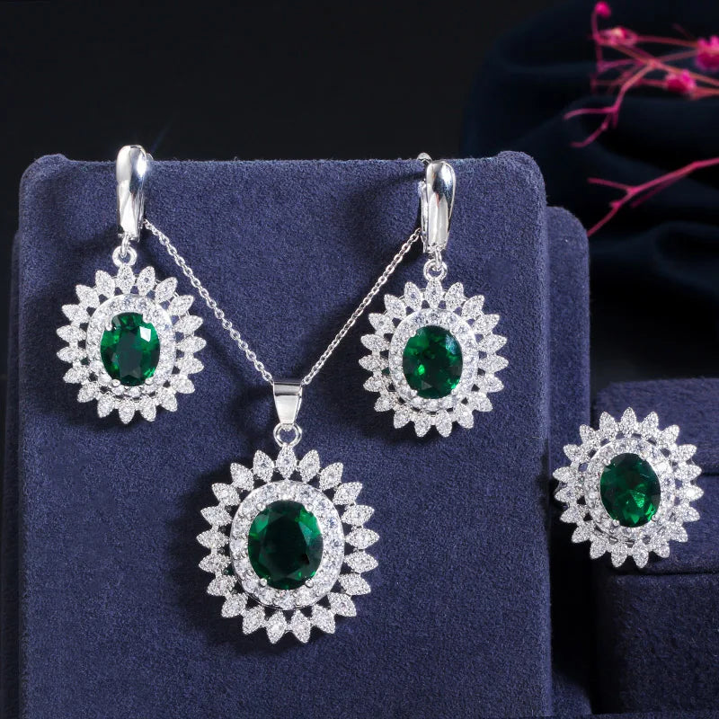 Green oval cubic zirconia jewelry set with flower-halo earrings, pendant necklace, and ring