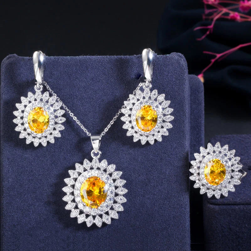 Yellow oval cubic zirconia jewelry set with flower-halo earrings, pendant necklace, and ring