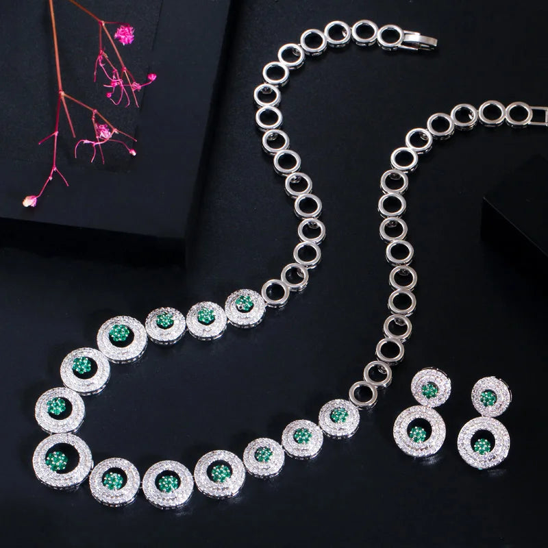 Silver-tone round zirconia necklace and matching drop earrings with green center stones