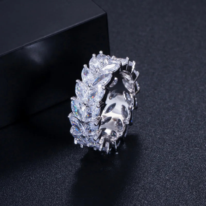 Silver-tone cubic zirconia ring with marquise stone cluster on dark display