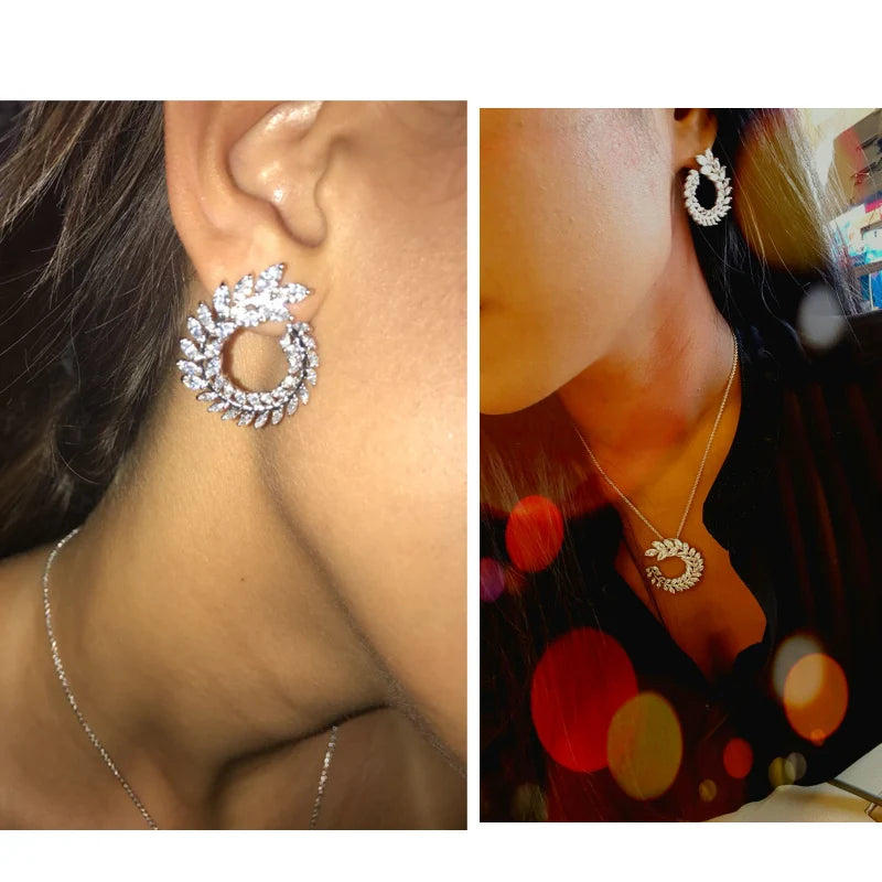 Silver-tone leaf CZ hoop earrings with circular wreath stones on ear