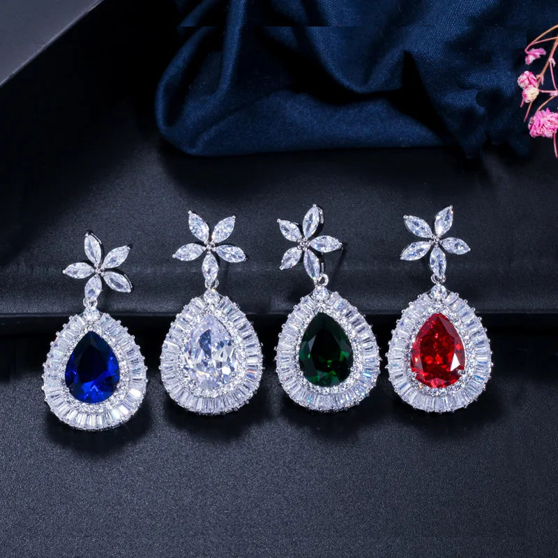 Four teardrop zircon earrings with flower studs in blue, clear, green, and red