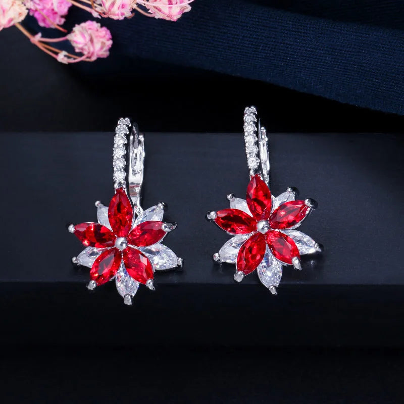 Pair of red flower earrings with clear gemstone petals and stone-set hoops