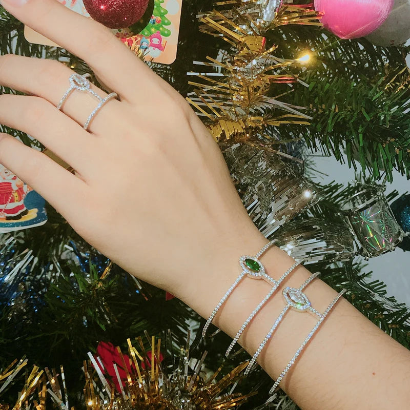 CZ double open cuff bangle and matching open ring on wrist with green accents