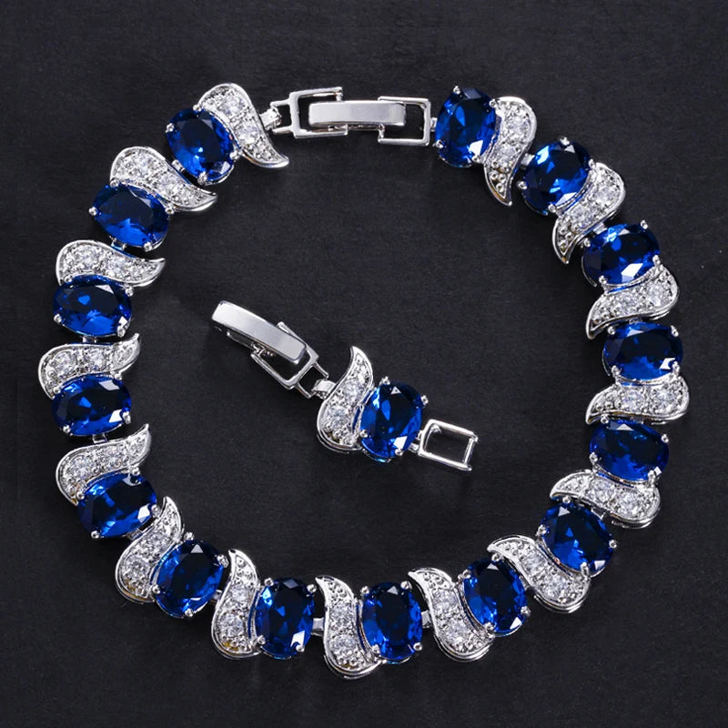 Blue oval crystal tennis bracelet with sparkling leaf-shaped accents and clasp