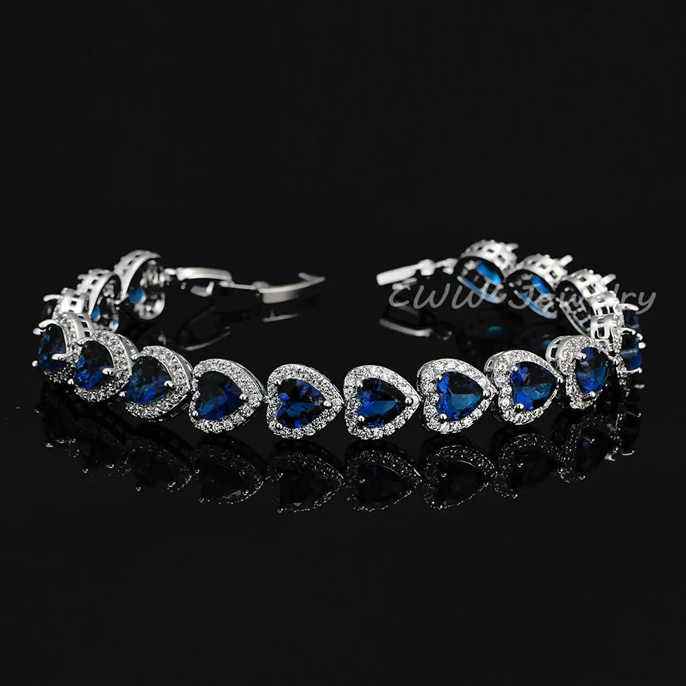 Silver-tone bracelet with deep blue heart crystals in halo settings