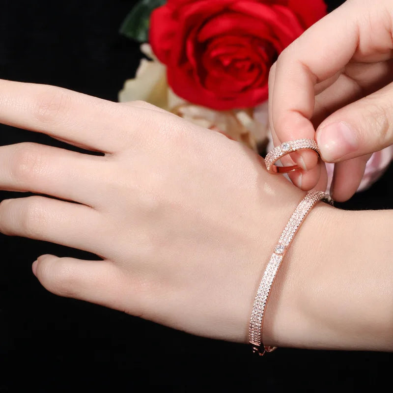 Rose gold bangle bracelet and matching ring with clear stones