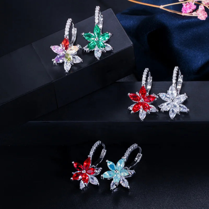 Flower earrings displayed in several colors, including red, green, blue, and clear