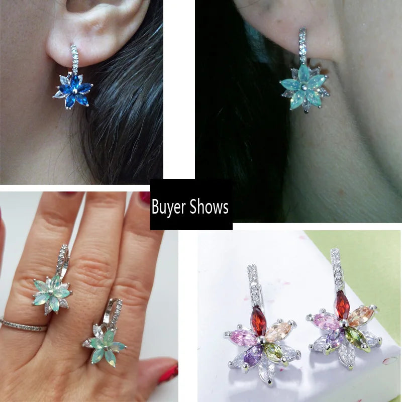 Flower earrings shown worn, with blue and pale multicolor gemstone petals