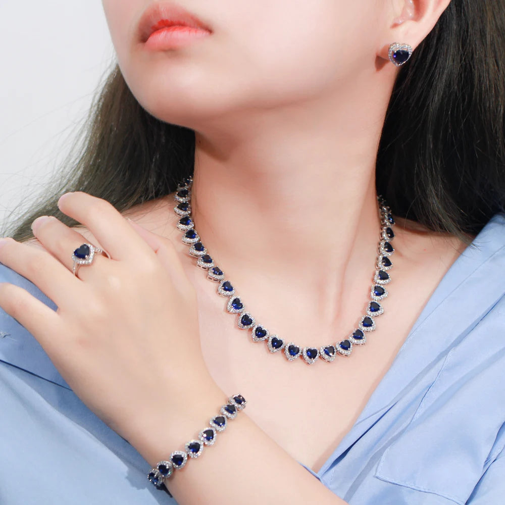Blue heart cubic zirconia bridal jewelry set on model: necklace, bracelet, ring, earrings