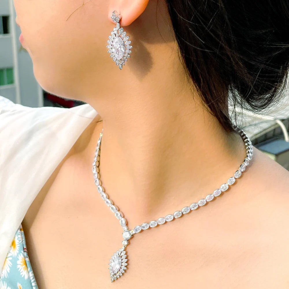 Silver tone cubic zirconia necklace with teardrop pendant and oval cluster drop earrings