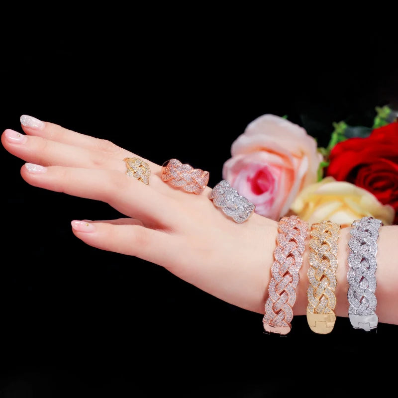CZ link bangle bracelets in rose, yellow, and silver with matching rings on hand