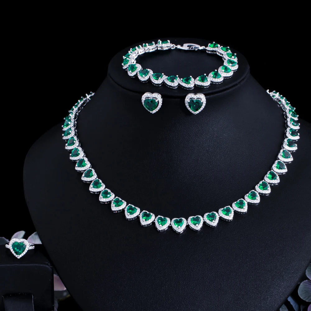Green heart cubic zirconia bridal jewelry set on display: necklace, bracelet, heart earrings