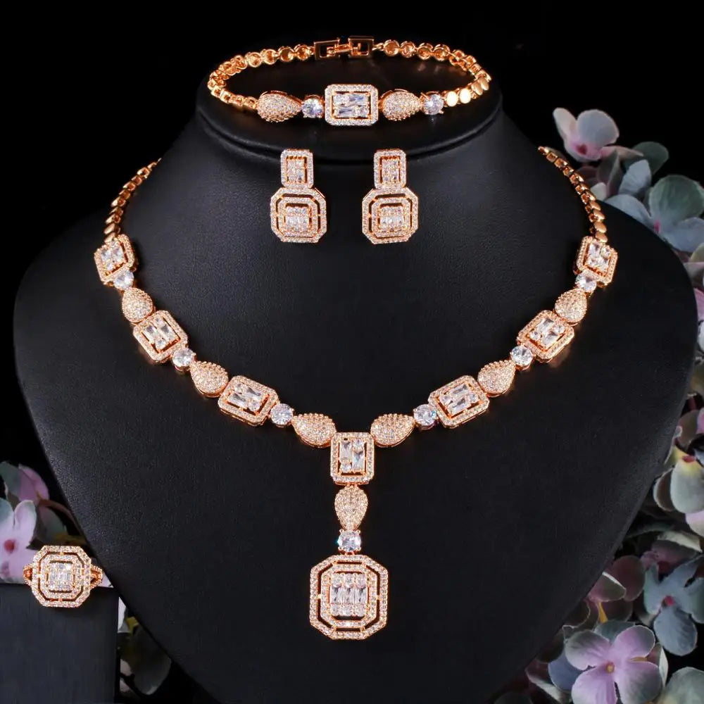 Gold-tone zirconia jewelry set with matching necklace, bracelet, and square stud earrings