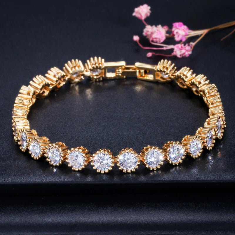 Gold-tone CZ tennis bracelet with round halo stones and a box clasp