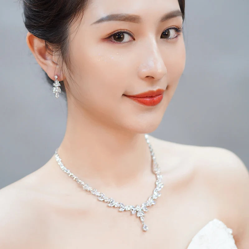 Silver leaf-drop cubic zirconia necklace and drop earrings on model portrait