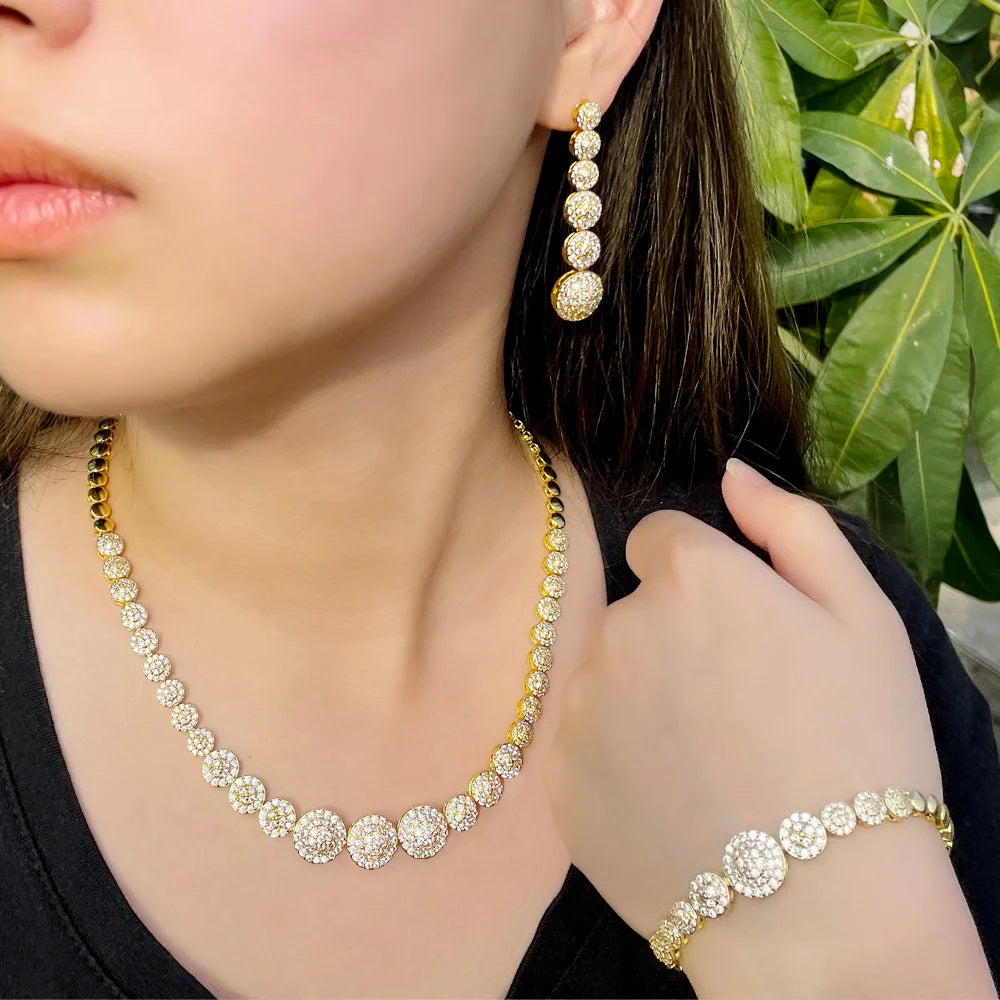 Gold-tone CZ jewelry set with graduated round stones, necklace, drop earrings and bracelet