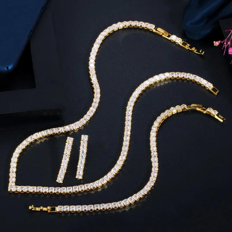 Gold cubic zirconia jewelry set with heart-shaped necklace, hoop earrings, and stud earrings