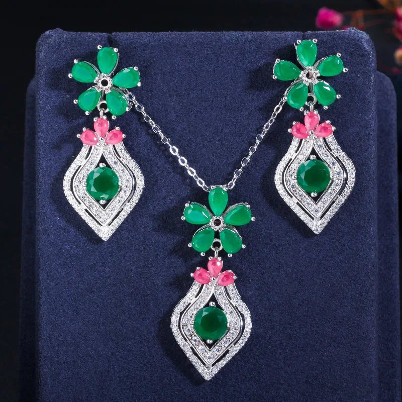 Silver-tone necklace and drop earrings with green flower motifs and pink crystal accents