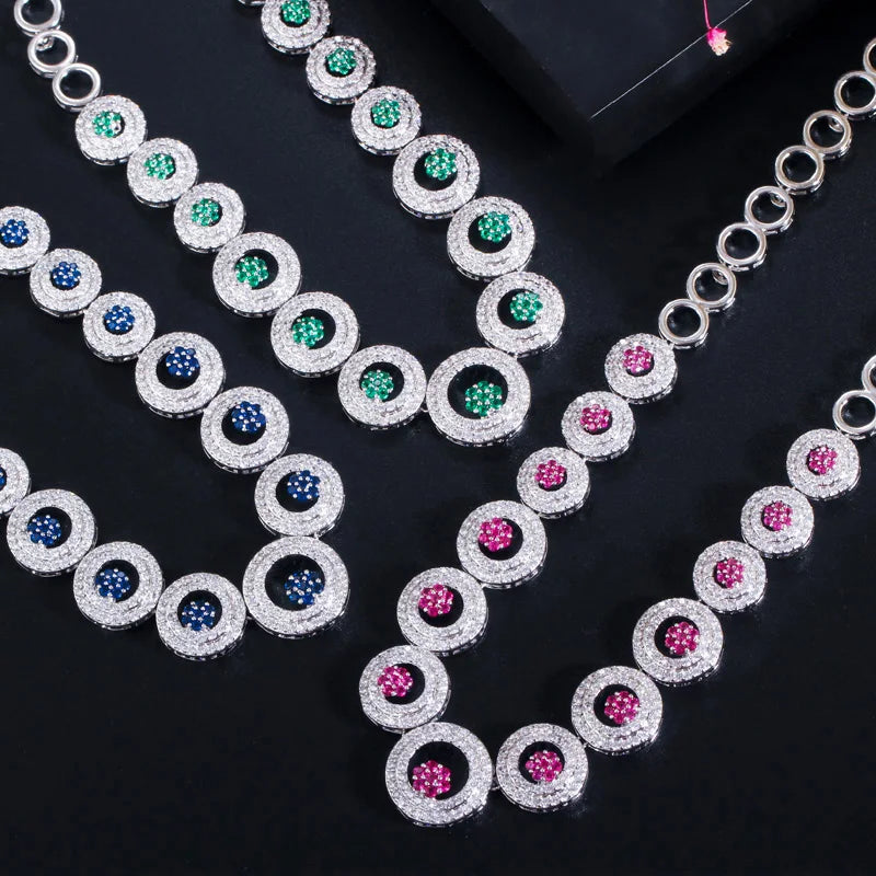 Silver tone round zirconia jewelry set with blue, green, and pink stones
