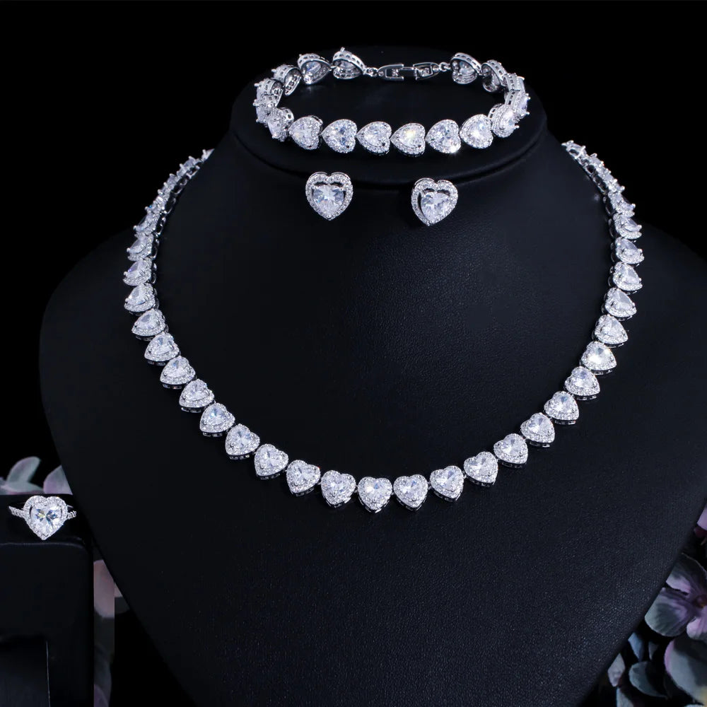 Clear heart cubic zirconia bridal jewelry set on display: necklace, bracelet, heart earrings