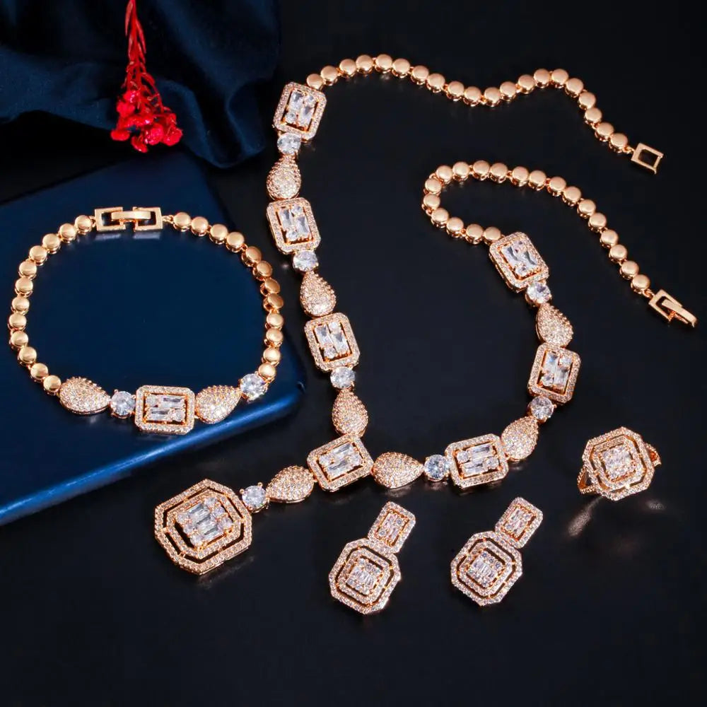 Gold-tone zirconia necklace and bracelet with square-link accents, plus matching drop earrings