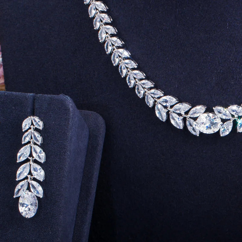 Silver-tone necklace and earring detail with leaf-shaped cubic zirconia stones