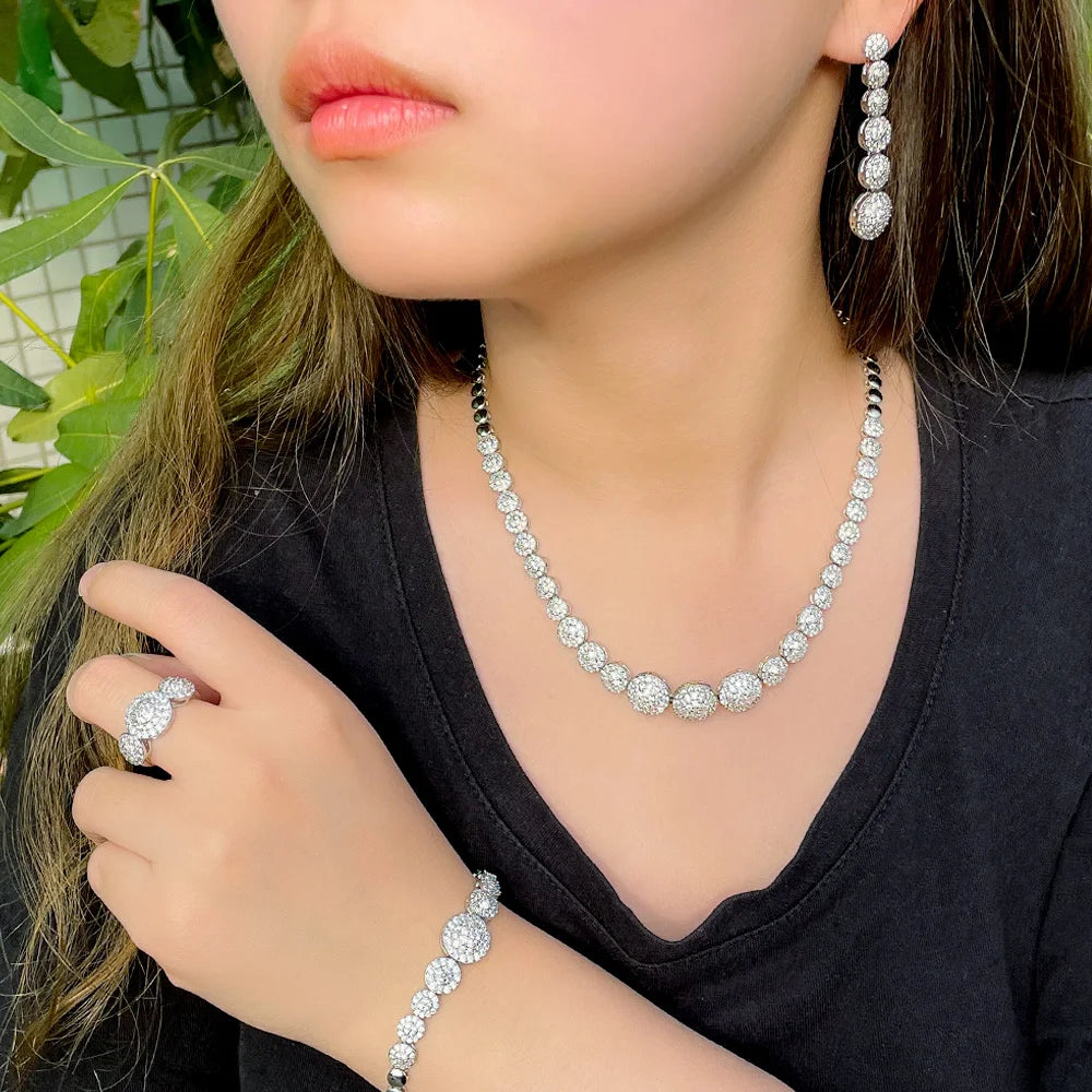 Silver-tone CZ jewelry worn as a necklace, drop earrings, bracelet and ring