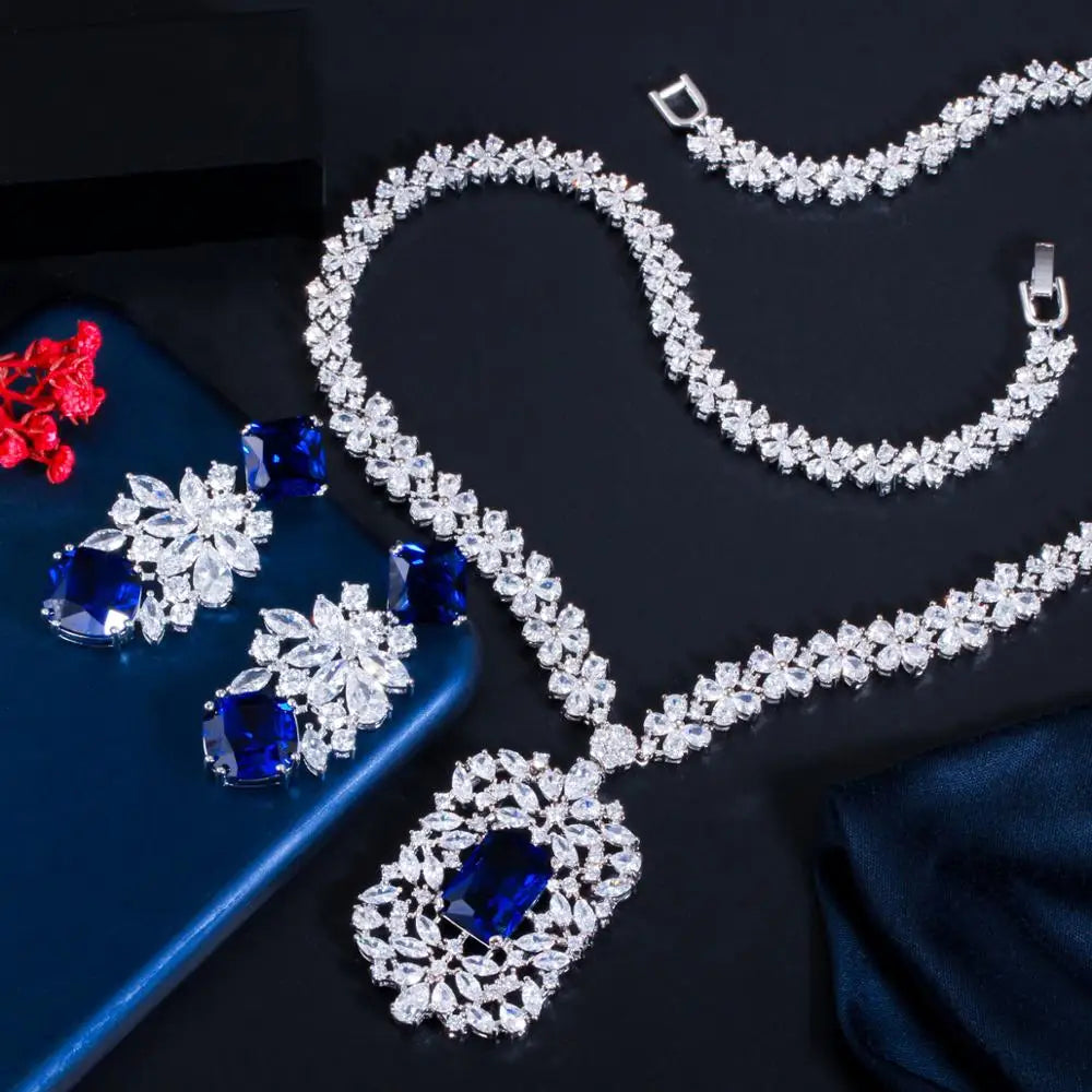 Cubic zirconia flower necklace and earring set with blue stones and clear crystal halo accents