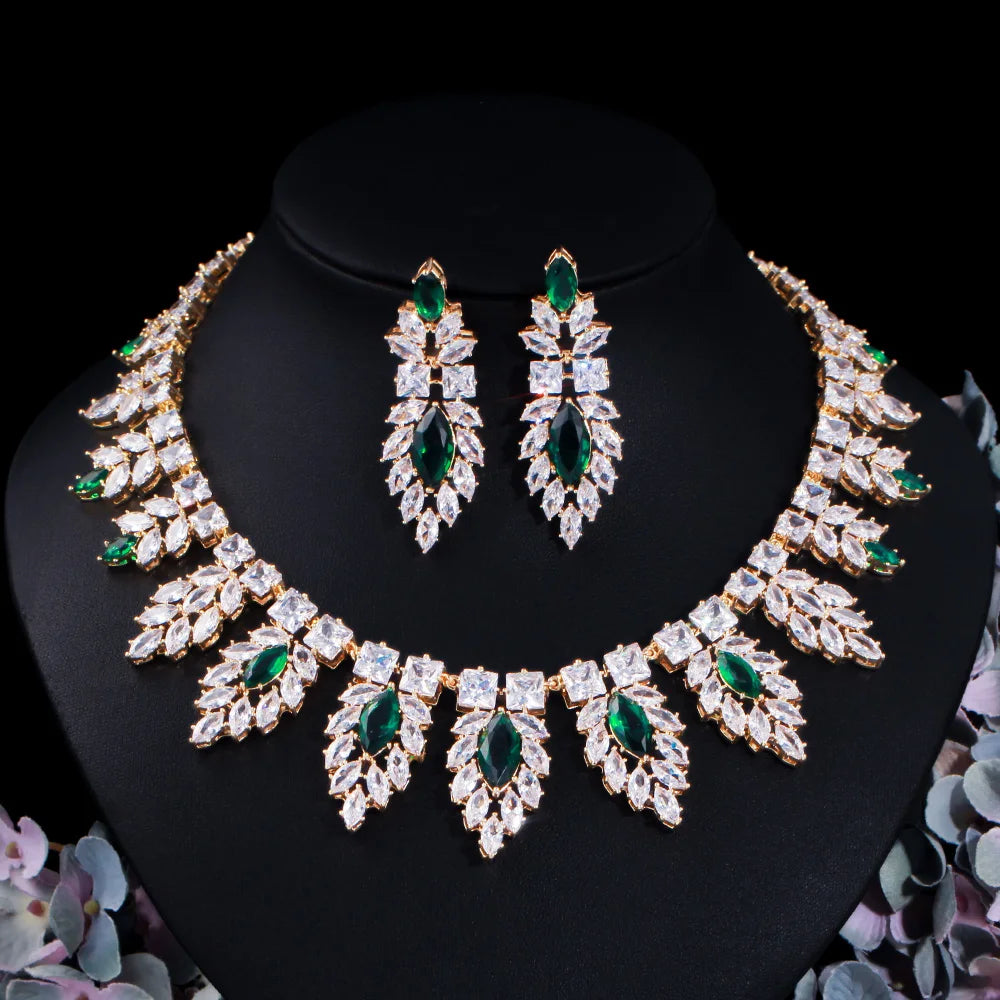 Silver-tone bridal jewelry set with green teardrop earrings and scalloped leaf crystal necklace