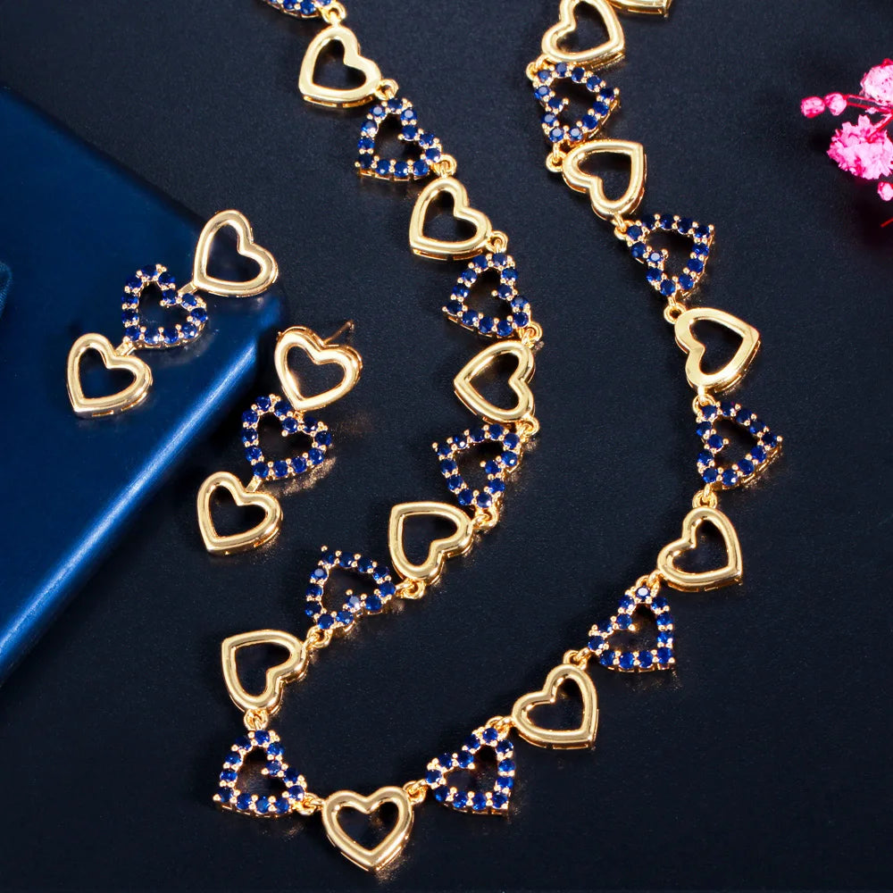 Gold-tone heart-link necklace and matching earrings with blue stones