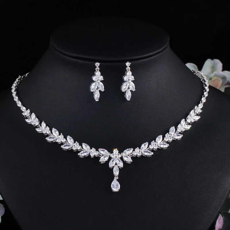 Silver leaf-drop cubic zirconia necklace and matching drop earrings on black bust