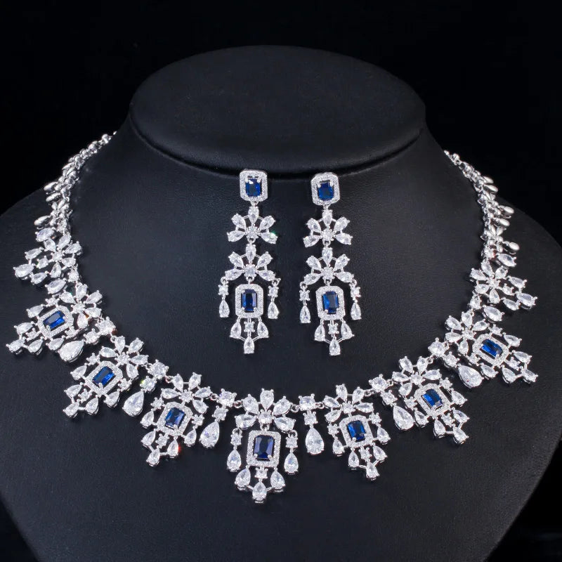 Cubic zirconia necklace and drop earrings set with blue square stones and silver-toned details