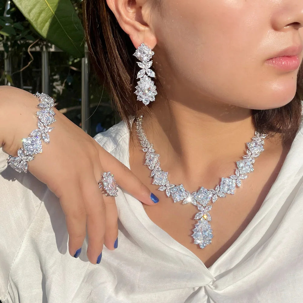 Women’s silver-tone CZ jewelry: green-stone necklace, drop earrings, bracelet, ring