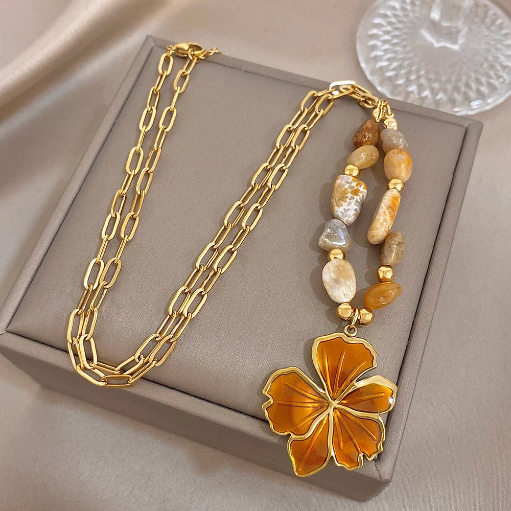 Gold plated necklace with orange enamel flower pendant and mixed natural stone beads