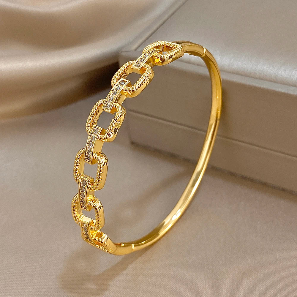 Gold-tone square-link cuff bracelet with clear zircon accents, open side view