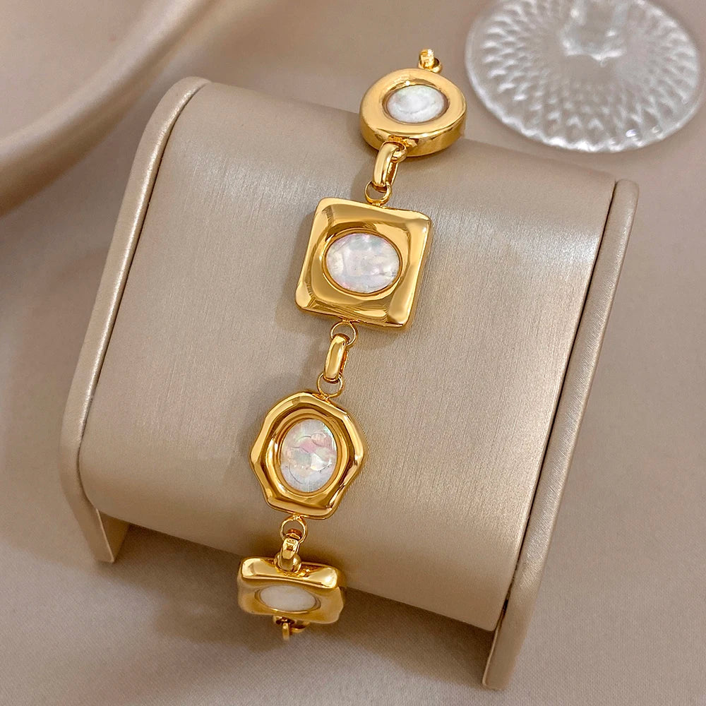 Gold-plated geometric shell bead bracelet with dangling square and oval white inlays